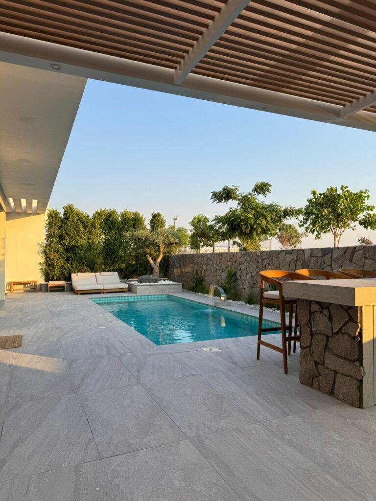 Luxury swimming pool construction with modern pergola design in Dubai